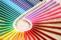 Colourful circle of wooden pencils on brown background, wooden table Royalty Free Stock Photo