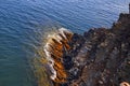 The colourful cliff and the vibrantly coloured seaweed.
