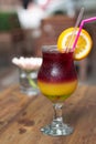 A colourful cocktail of banana liqueur, green Midori, orange juice and red wine Royalty Free Stock Photo