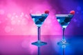 Colourful cocktails garnished with berries, background with light effects