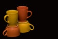 Colourful coffee mugs on a black background