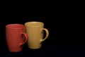 Colourful coffee mugs on a black background