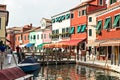 Colourful colorful houses and shops alongside canal on island of Burano, in Venetian lagoon, Italy