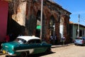 Colourful contrasts in Trinidad-City with rotten colonial buildings and oldtimer cars Royalty Free Stock Photo