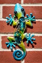 Colourful Decorative Gecko on a red brick wall