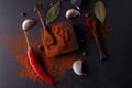 Colourful different spices on black stone plate. Spicy cooking