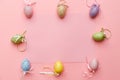 Colourful easter eggs on pink background with copy space.