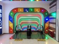 Colourful entrance or exit for an escalator.