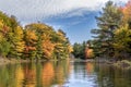 Colourful fall leaves reflecting on the lake in October Royalty Free Stock Photo