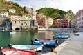 Colourful fishing boats in small marina of Vernazza, one of the five centuries-old villages of Cinque Terre, located on rugged Royalty Free Stock Photo
