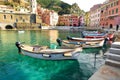 Colourful fishing boats in small marina of Vernazza, one of the five centuries-old villages of Cinque Terre, located on rugged Royalty Free Stock Photo