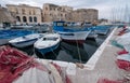 Colourful fishing nets in the harbour in Gallipoli, Puglia Italy. Plastic fishing nets can be polluting and a danger to sea life.