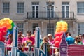 Colourful float with people on board and decorated with balloons, on Regent Street during the Gay Pride Parade 2018 in London.