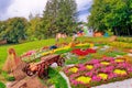 Colourful Flowerbeds and a wheelbarrow off to the side in an Attractive Ukrainian Formal Garden.