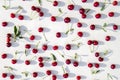 Colourful fresh bright pattern with ripe red cherry and leaf on marble table. Top view, flat lay Royalty Free Stock Photo
