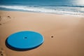 A colourful frisbee on a sandy beach