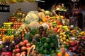 Colourful fruit market stall in Boqueria in Barcelona. Stall of avocado, peach, mango, apple and other exotic fruits at Royalty Free Stock Photo