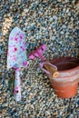 Colourful garden tools with terracotta clay flower pots on a gravel background Royalty Free Stock Photo