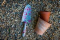 Colourful garden tools with terracotta clay flower pots on a gravel background Royalty Free Stock Photo