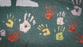Colourful hands painted on a grey textured wall Royalty Free Stock Photo