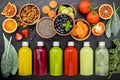 Colourful healthy smoothies and juices in bottles on dark stone background . Royalty Free Stock Photo