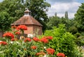 Colourful herbaceous border with red Silene Chalcedonica flowers in the foreground, at Eastcote House Gardens, London UK.