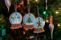 Homemade snow globe sugar cookies hanging on a Christmas tree. Royalty Free Stock Photo