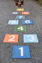 Colourful hopscotch playground markings numbers on stone at Pavement
