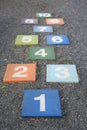 Colourful hopscotch playground markings numbers on stone at Pavement