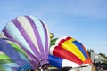 Colourful hot air balloons being filled with hot air at festival