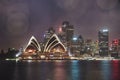 Colourful illuminated Sydney Opera house by lights at night with Royalty Free Stock Photo