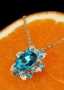 colourful jewellery pendant with gems and diamonds on orange background