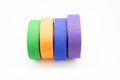 Colourful karate belt of green, yellow, purple and blue on white background Royalty Free Stock Photo