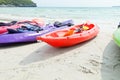 Colourful kayaks on the beach.