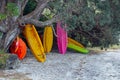 Colourful Kayaks stacked under a tree Royalty Free Stock Photo