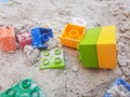 colourful kids plastic blocks laying on the sand