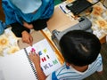 Colourful letters on the book as reference for the child to type into the braille typwriter