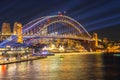 Colourful Light show at night on Sydney Harbour NSW Australia. The bridge illuminated with lasers and neon coloured lights