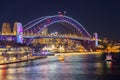 Colourful Light show at night on Sydney Harbour NSW Australia. The bridge illuminated with lasers and neon coloured lights Royalty Free Stock Photo