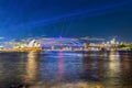 Colourful Light show at night on Sydney Harbour NSW Australia. The bridge illuminated with lasers and neon coloured lights