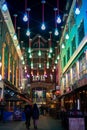 Colourful lights suspended above shoppers as part of the Carnaby Street Christmas decorations