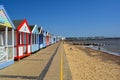 Colourful line of beach huts and pier