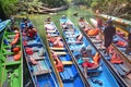 Colourful long boats stopping and waiting for tourists