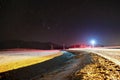 A colourful long exposure nightshot landscape with mountains and road in winter Royalty Free Stock Photo