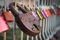 Colourful love padlocks shut to railing on Eiserner Steg bridge in Regensburg, Germany