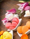 Colourful macaroons and tulips on table
