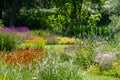 Colourful mature garden influenced by the naturalistic planting at Bressingham Gardens, Diss, Norfolk UK