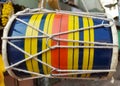 A colourful musical indian instrument called Dhol , mainly used during puja, after immersion of idols ,kept in hanging position.