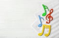 Colourful musical notes lying on music sheets Royalty Free Stock Photo