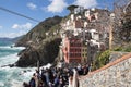 Colourful old houses and tourist in fisherman village Riomaggiore, Cinque Terre, Liguria, Italy Royalty Free Stock Photo